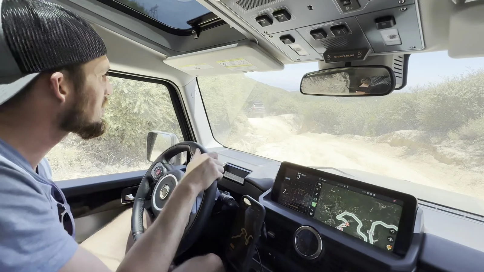 Driving the Grenadier off-road with the trail map on the dash